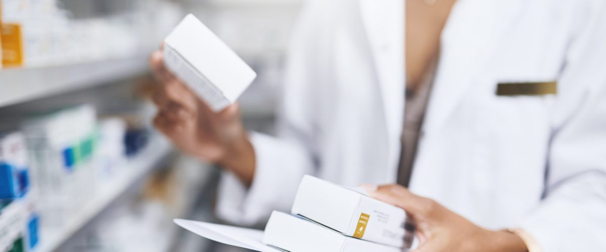 Pharmacist, hands and drug box in hands in pharmacy, person and filling customer medical prescription for healthcare. Professional, medication and retail dispensary or career, supplements and patient.